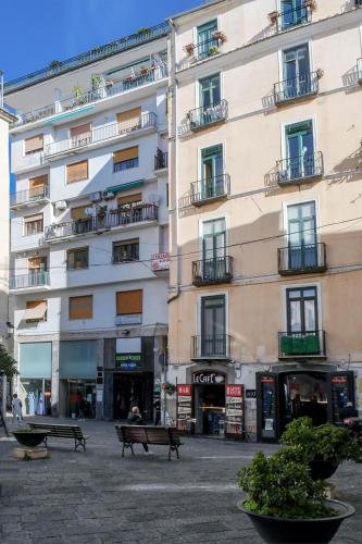 a large building with benches in front of it at Edahouse in Salerno
