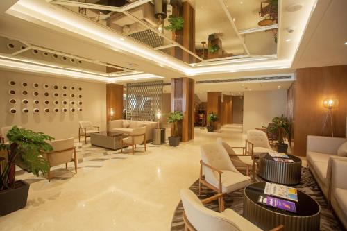 a lobby with a waiting room with couches and chairs at ARISTA BY AMBITION in Guwahati