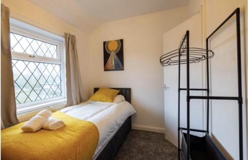 a bedroom with a bed and a window at Immaculate 2-Bed Duplex Apartment in Leeds in Leeds
