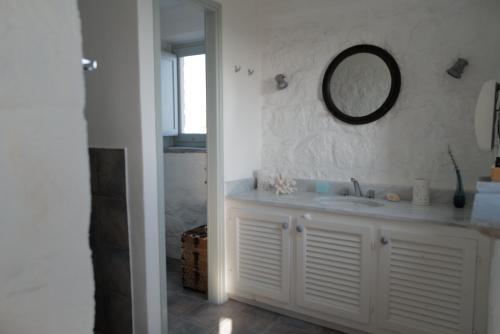 a bathroom with a sink and a mirror on the wall at VillainPatmos in Patmos
