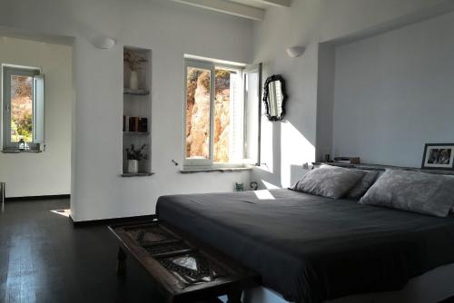 a bedroom with a bed and two windows at VillainPatmos in Patmos