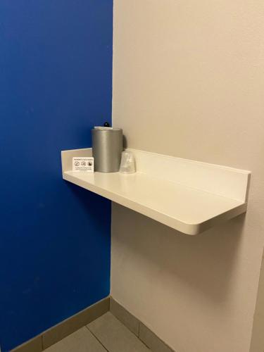 a shelf on a wall with a trash can on it at Holiday Inn Express Metropolis by IHG in Metropolis