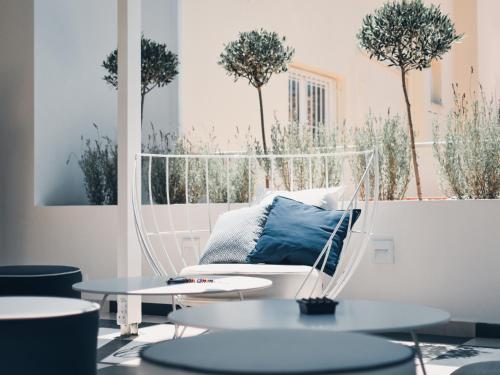 a room with a couch and two tables and trees at BLUE LUXURY SUITES in Preveza