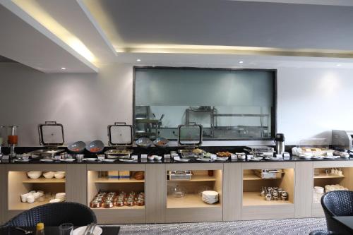 a counter with a large screen in a room at Ahuja Residency Mayfield Garden in Gurgaon