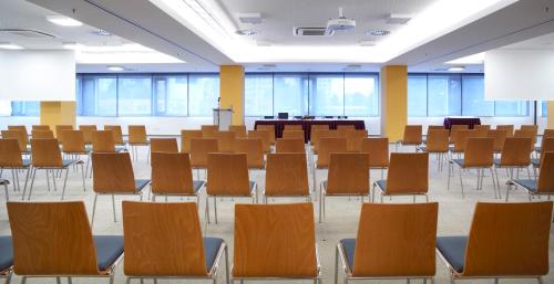 an empty lecture room with chairs and tables at Clarion Congress Hotel České Budějovice in České Budějovice