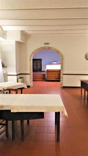 an empty room with tables and a bed in the background at camere in Villa Luzi in Treia