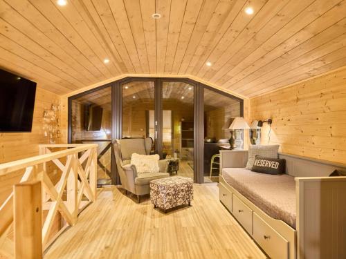 a bedroom with a bed and a chair in a room at Chalet Luxe Timber Lodge & Yoga Loft by Interhome in Mladé Buky