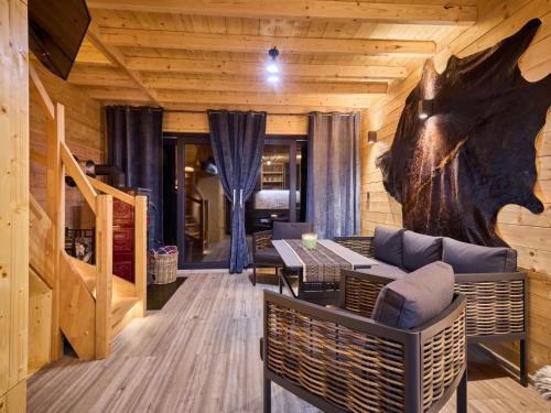a room with a table and chairs in a cabin at Chalet Luxe Timber Lodge & Relaxing Bath by Interhome in Mladé Buky