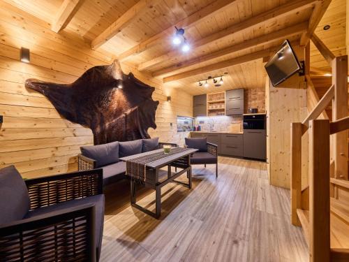 a living room with a table and a kitchen at Chalet Luxe Timber Lodge & Relaxing Bath by Interhome in Mladé Buky