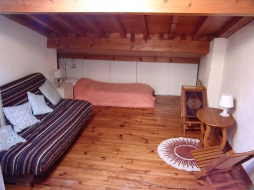 a bedroom with a bed and a table in a room at Maison Cosy et Conviviale, Le B7 in Besset