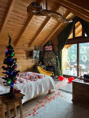 a bedroom with a christmas tree in a room at Peruma otel bungalov in Çamlıhemşin