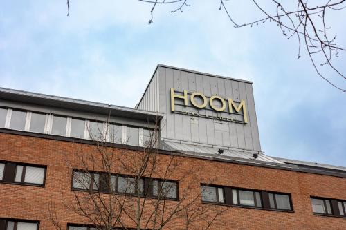 a building with a sign on top of it at HOOM Park & Hotel in Solna