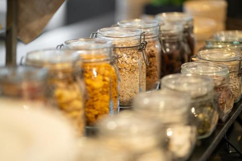 a group of jars filled with different types of food at Solna Park & Hotel in Solna