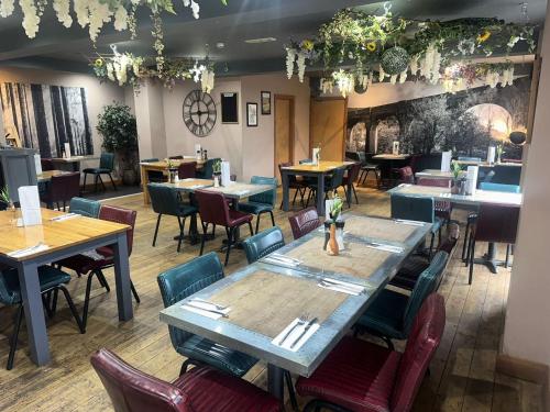 a restaurant with tables and chairs in a room at Afan Lodge in Port Talbot