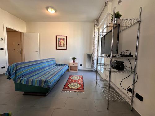 a living room with a bed and a flat screen tv at APPARTAMENTO LIDA in Lazise