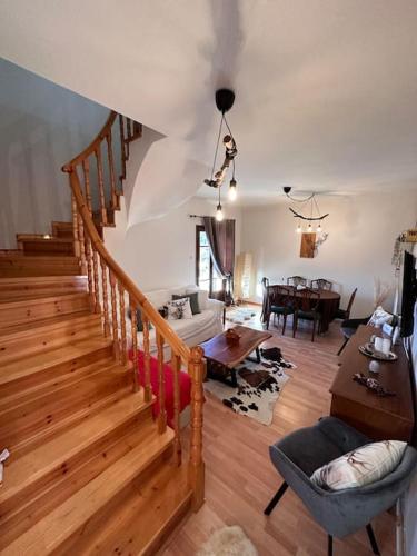 a living room with a staircase and a dining room at Casa Di Munti in Konitsa