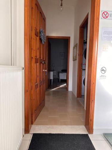 a hallway with an open wooden door and a room at Casa Di Munti in Konitsa
