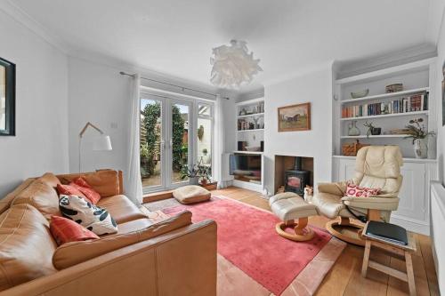 a living room with a couch and a chair at St John's Corner Cottage, Bury St. Edmunds in Bury Saint Edmunds