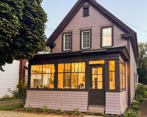 a house with a lot of windows at Spin & Sip - Dog-Friendly Vinyl Vibes Downtown in Fredericton