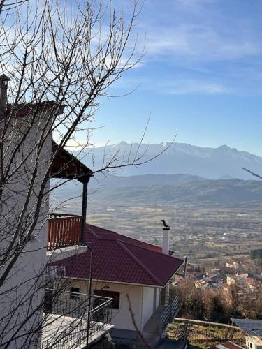 a building with a balcony and a bird on top of it at Casa Di Munti in Konitsa