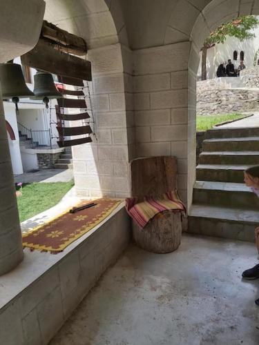 a bench sitting inside of a building with stairs at Casa Di Munti in Konitsa