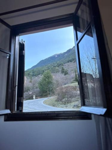 a window with a view of a winding road at Casa Di Munti in Konitsa