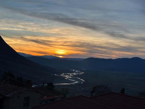 a view of a river at sunset with mountains at Casa Di Munti in Konitsa