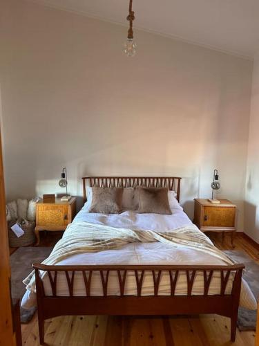 a bedroom with a large bed with two night stands at Casa Di Munti in Konitsa