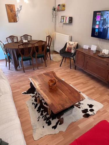 a living room with a wooden table and chairs at Casa Di Munti in Konitsa