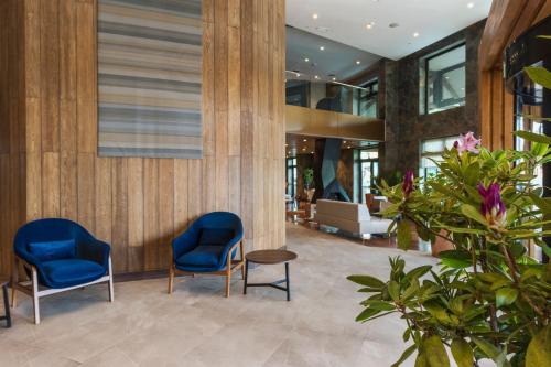 two blue chairs and a table in a lobby at Courtyard by Marriott Puerto Montt in Puerto Montt