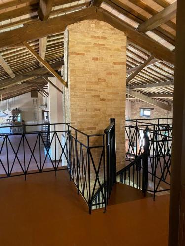 a staircase in a room with a brick wall at camere in Villa Luzi in Treia