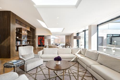 a living room with a white couch and a table at Park Hyatt Vienna in Vienna