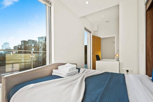 a bedroom with a bed and a large window at Bright & Modern Two Bedroom Flat in Hoxton in London