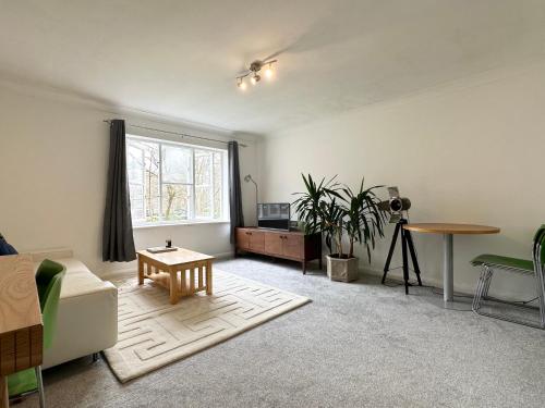 a living room with a couch and a table at Spacious Quiet Stylish entire flat in London