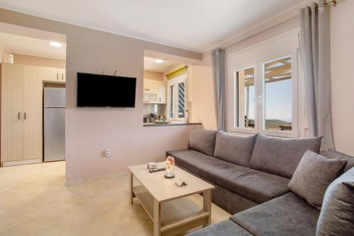 a living room with a couch and a table at Iliovasilema Holiday House in Volimes