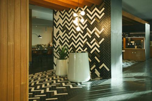 a lobby with two vases and a wall with chevrons at Salobre Hotel Resort & Serenity in Salobre