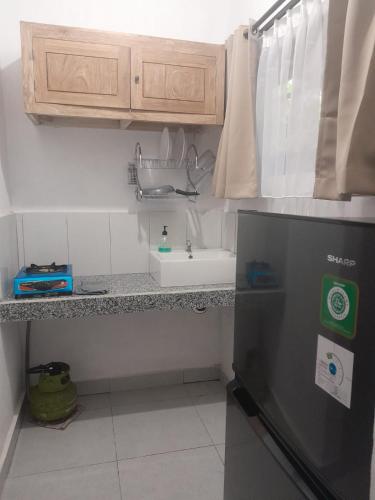 a kitchen with a sink and a counter top at Bali Bakas House II in Banjarangkan