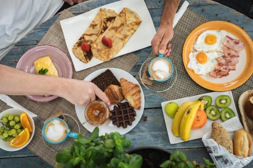 a table with a bunch of breakfast foods on it at Buendía Corralejo Nohotel in Corralejo
