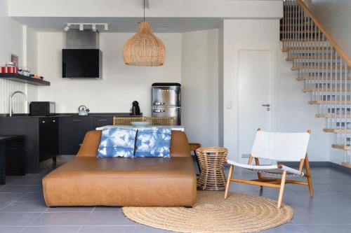 a living room with a couch and a chair at Buendía Corralejo Nohotel in Corralejo