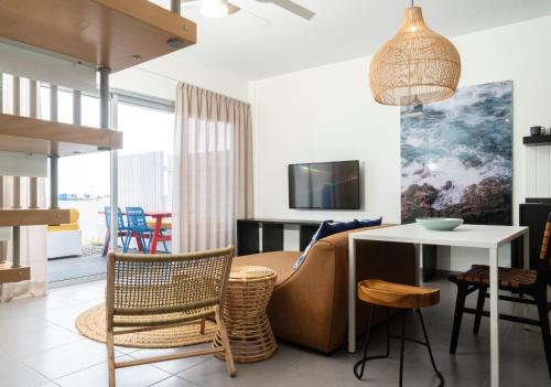 a living room with a couch and a table at Buendía Corralejo Nohotel in Corralejo
