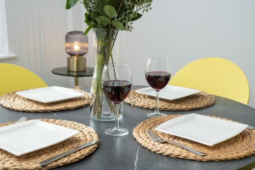 a table with two glasses of red wine on it at Heath House in Burton upon Trent