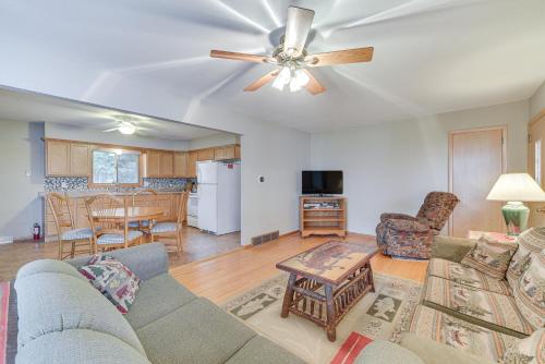 a living room with a couch and a ceiling fan at Waterfront Lake Holcombe Getaway with Dock in Conrath