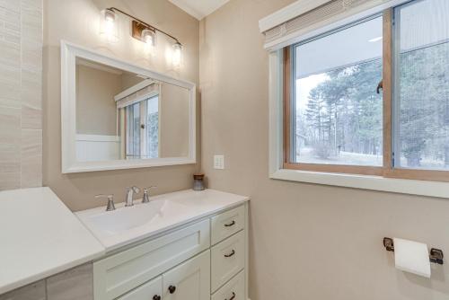 a bathroom with a sink and a window at Waterfront Lake Holcombe Getaway with Dock in Conrath