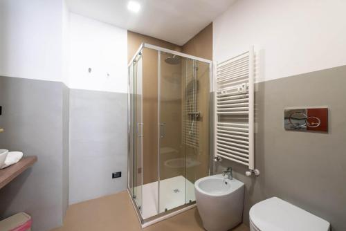 a bathroom with a shower and a toilet and a sink at Torino Station Relais in Turin
