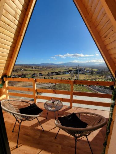 a porch with two chairs and a table on it at Kuća za odmor Villa Kovačević in Bihać
