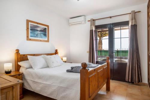 a bedroom with a bed and a window at Villa Kanak in Puerto del Carmen