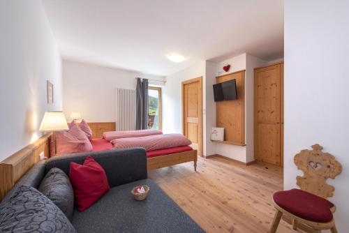 a living room with a couch and a bed at Gemangerhof in Bressanone