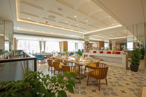 a dining room with tables and chairs in a restaurant at ARISTA BY AMBITION in Guwahati