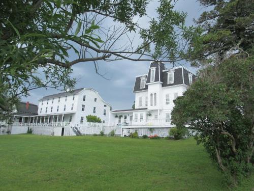a large white building with a black roof at Marathon Hotel in North Head