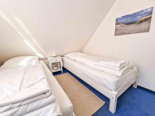 a room with two beds in a small room at Nimo 2 in Greetsiel
